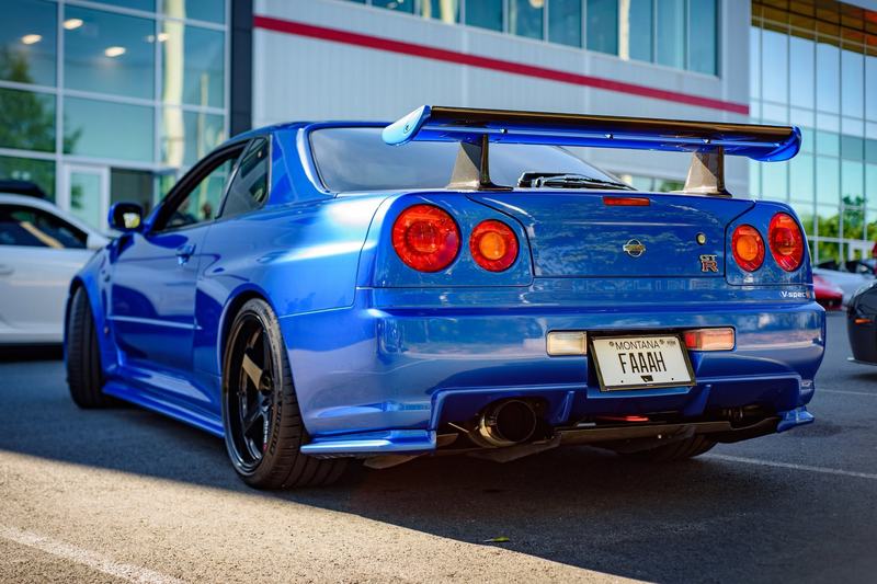 A Bayside Blue Nissan Skyline R34 GT-R from behind, its Montana plate marked PERM for permanent registration. Photo: Justin Smith